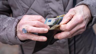 Older person holding cash