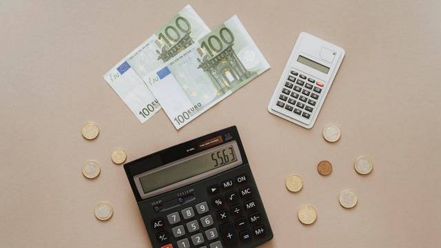 Euro bills, coins, and calculator