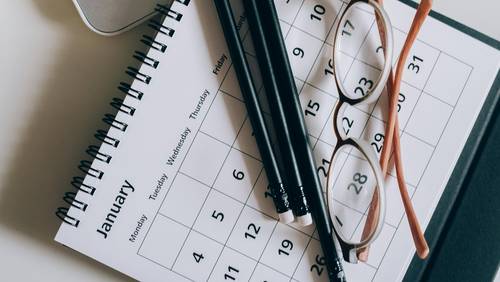 Pencil and glasses on a calendar