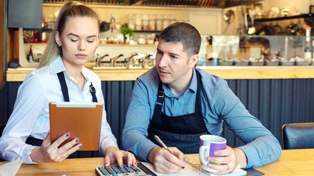 Two restaurant owners discussing bills