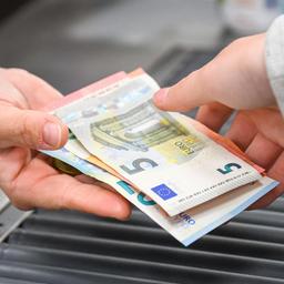 A cashier handing cash to a customer