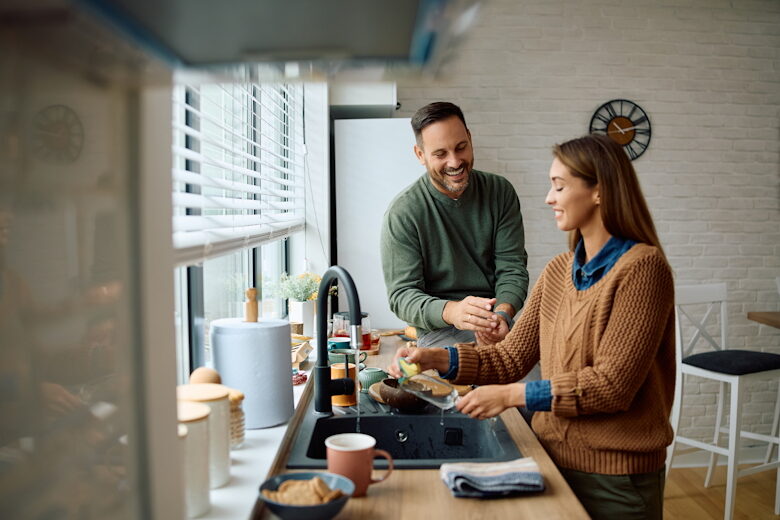Man and woman discussing finances at kitchen counter