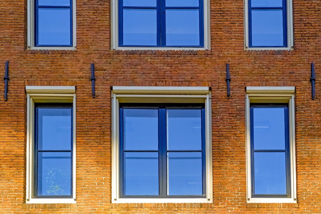 A Dutch homebuyer standing in a living room, looking at the potential of a property with an energy label E