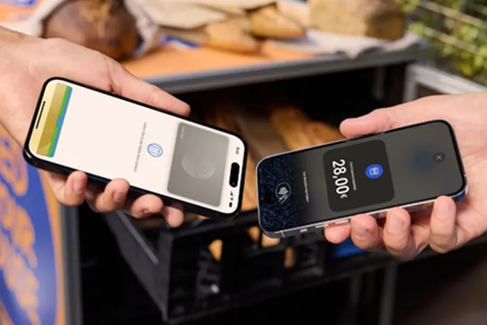 Two people holding smartphones for contactless payment