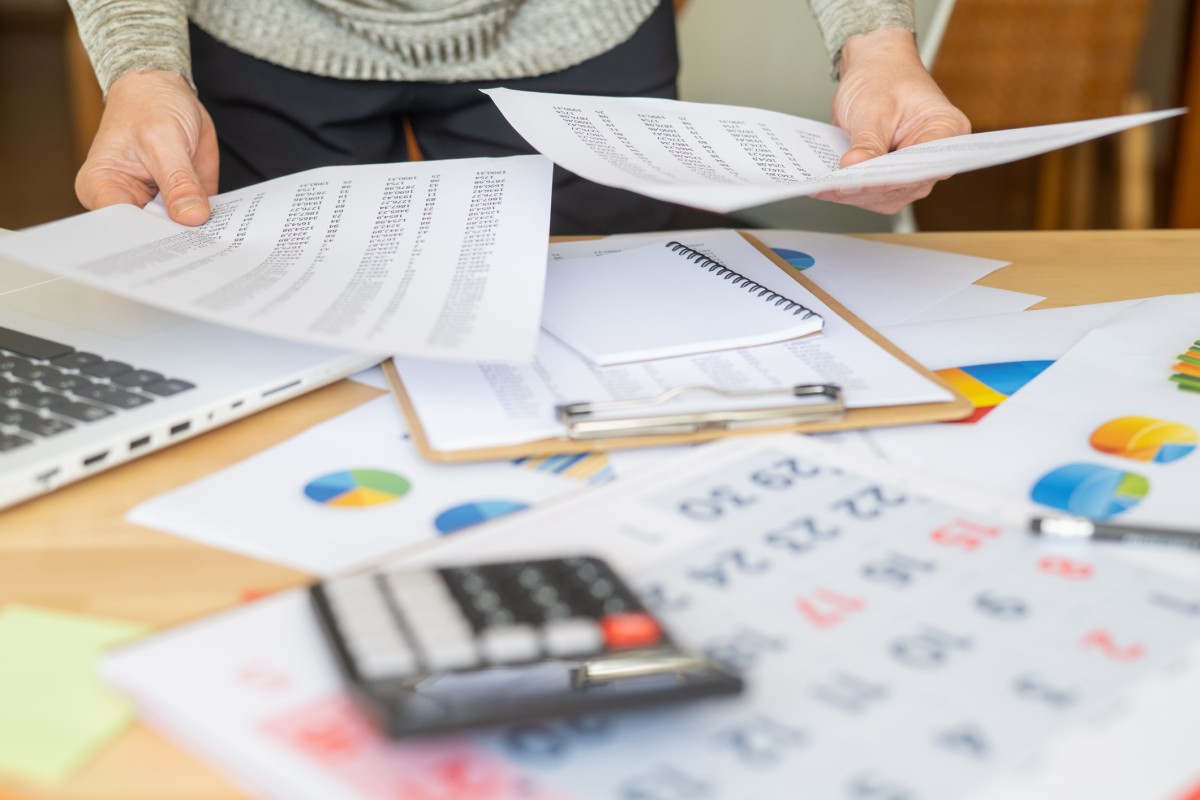 Person sorting through tax documents and depot statements