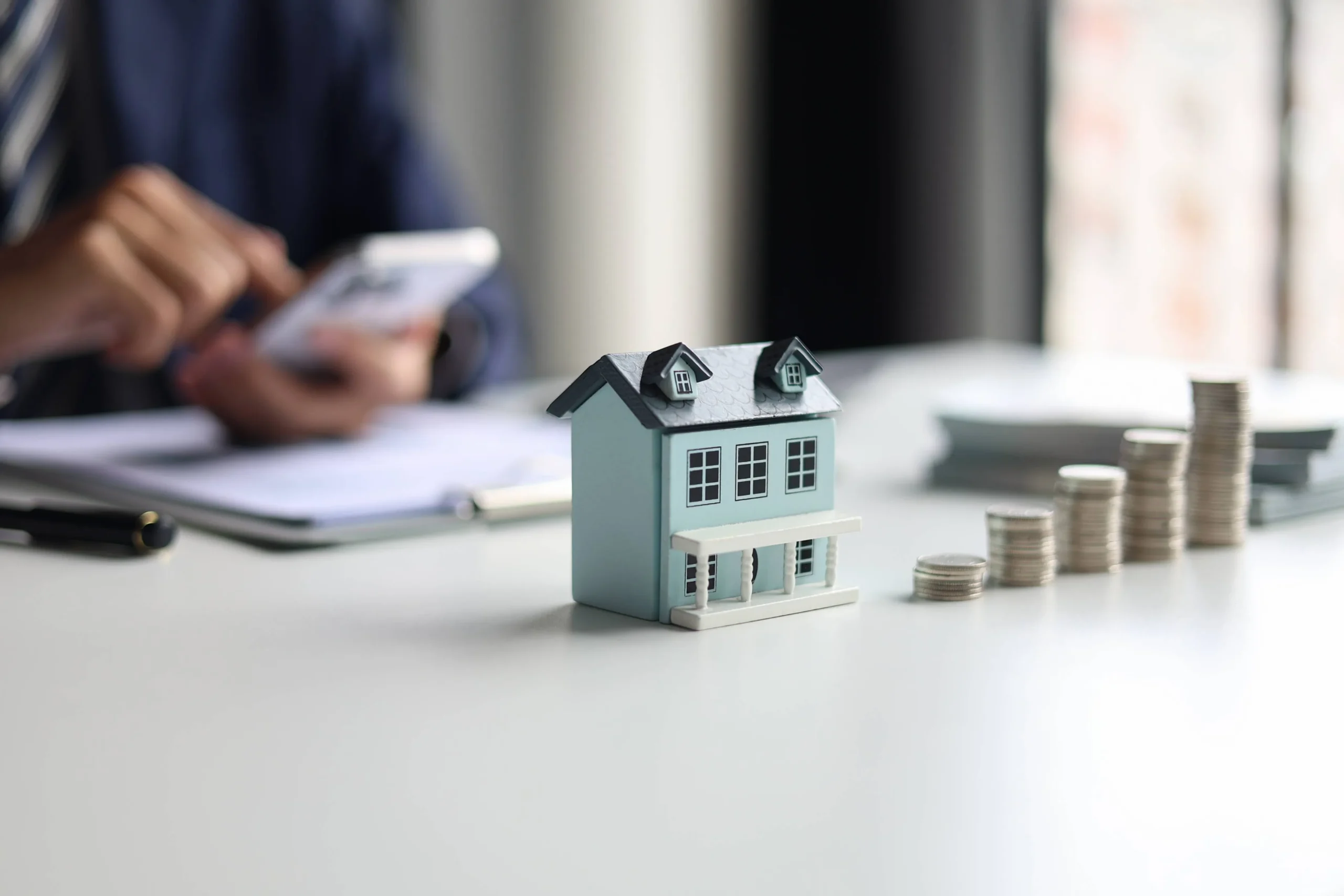 Real estate agent calculating homebuying costs versus rental expenses