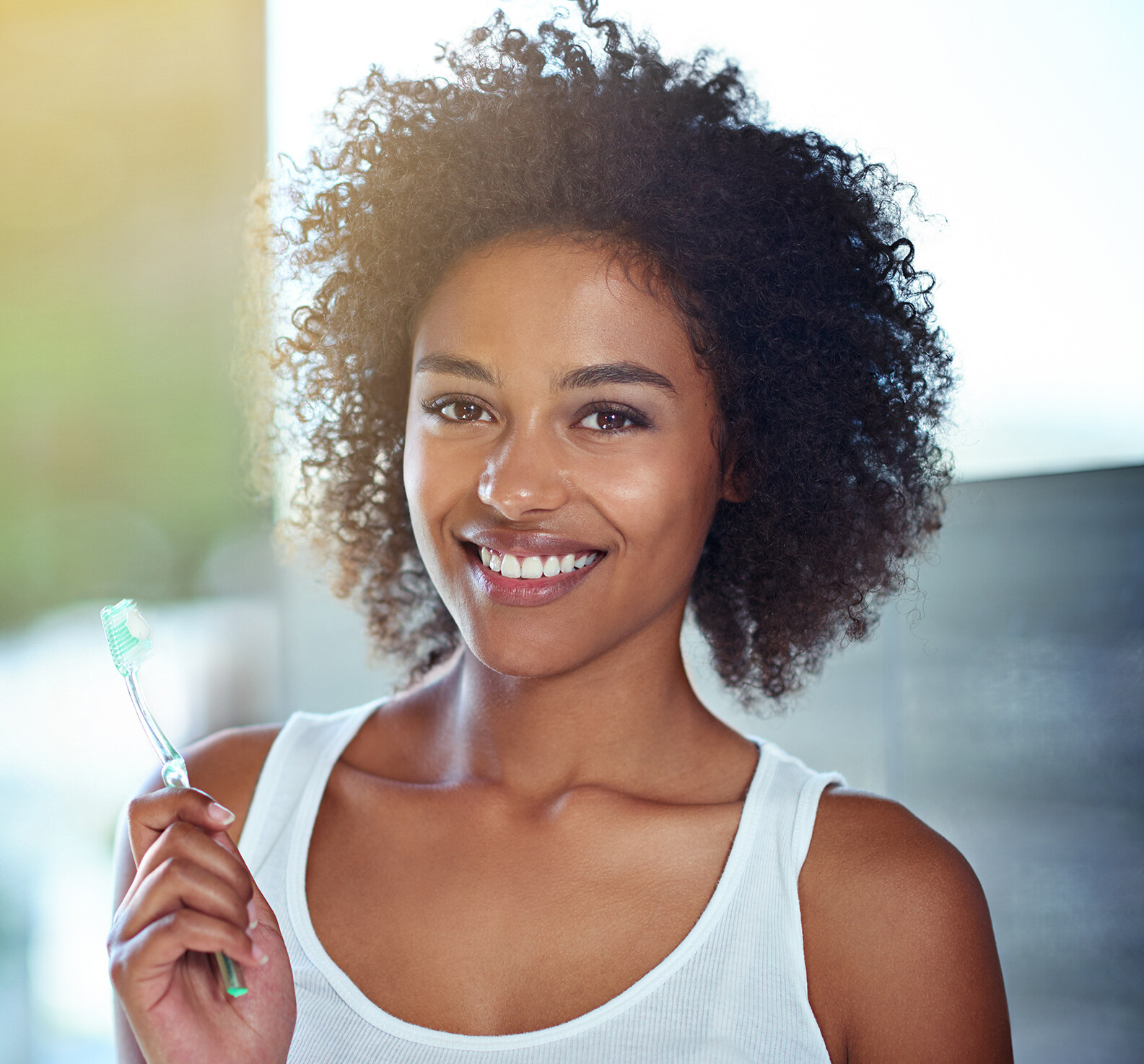 Young woman smiling showing healthy teeth representing dental health in Germany