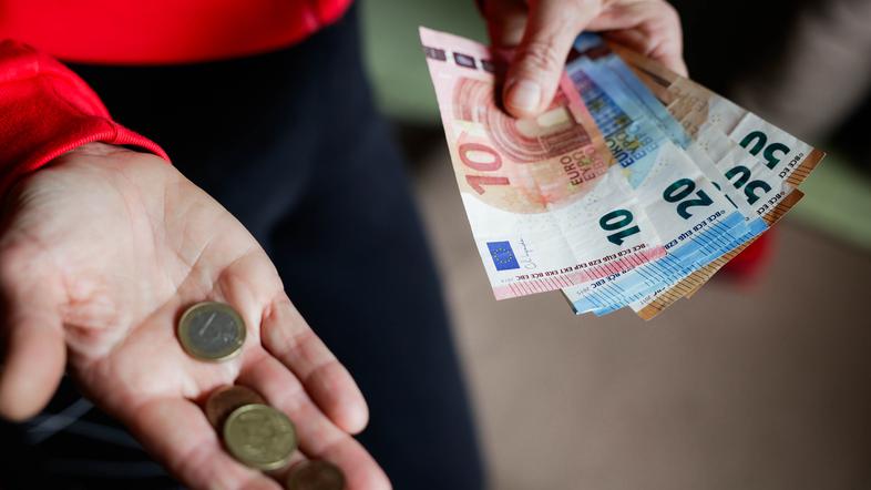 Money banknotes coins Slovenian currency representing investment costs and savings